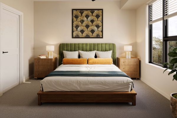 A modern bedroom with a green headboard, wooden furniture, large window, and geometric wall art above the bed.